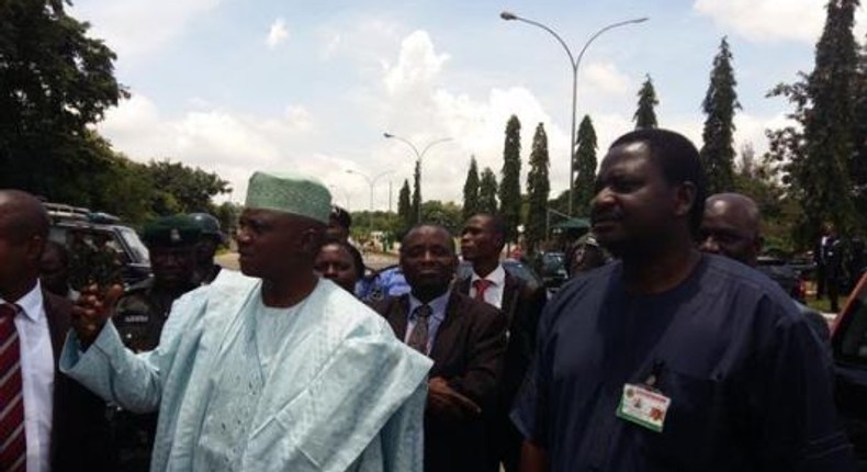 Presidential media aides, Femi Adesina and Garba Shehu speak to protesters at the Presidential Villa on August 17, 2015.