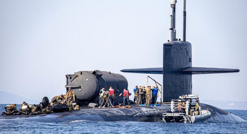 US Marines train with rubber raiding craft aboard US Navy submarine USS Georgia near Souda Bay, Greece, March 27, 2022.