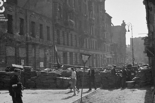 Barykada na ulicy Brackiej, Śródmieście Północne. Ujęcie spod domu przy ul. Brackiej 21 w kierunku południowym. Za barykadą po lewej: fragment ruin kamienicy Jaroszyńskiego (nr 20), kamienica Kiersnowskiej (nr 18) i częściowo zburzona kamienica Stöla (nr 16)