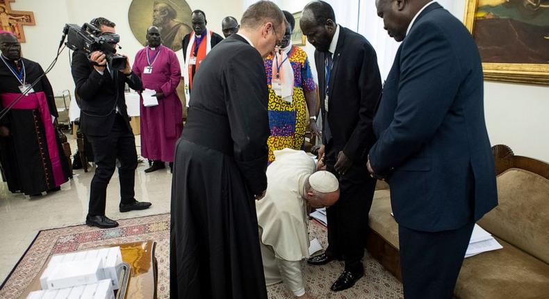 Pope Francis kneels to kiss the feet of South Sudan's President Salva Kiir