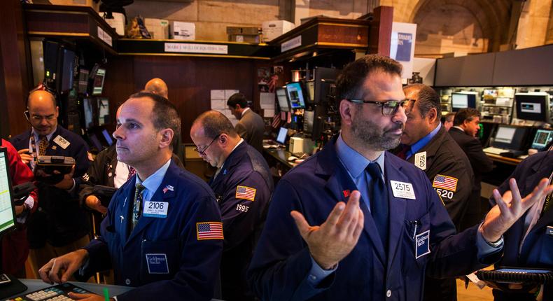 Traders work on the floor of the New York Stock Exchange shortly after the start of trading August 6, 2014.