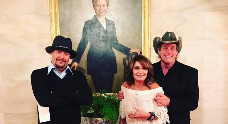 Kid Rock, Sarah Palin, and Ted Nugent pose with a White House portrait of Hillary Clinton