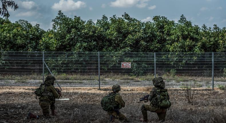 Israeli soldier scanning the area around Kfar Aza on October 10, 2023.Ilia Yefimovich/picture alliance via Getty Images