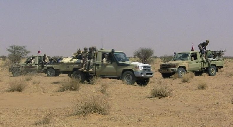 Fighters from the Tuareg separatist rebel group MNLA drive in the desert near Tabankort, February 15, 2015. REUTERS/Souleymane Ag Anara