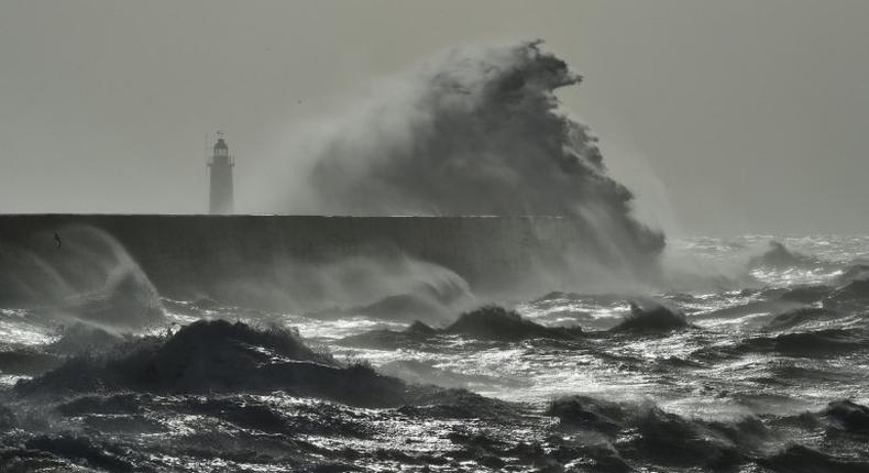 Waves crash over Newhaven Lighthouse on the south coast of England on February 23, 2017 as Storm Doris hits the country