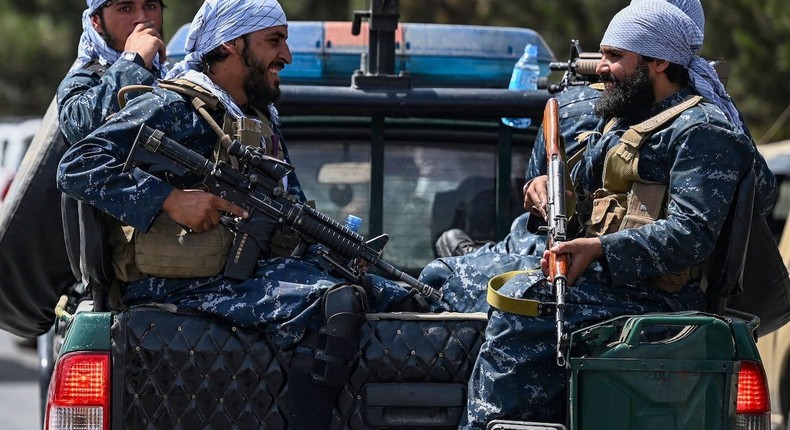 Taliban fighters patrol a street in Kabul, Afghanistan.
