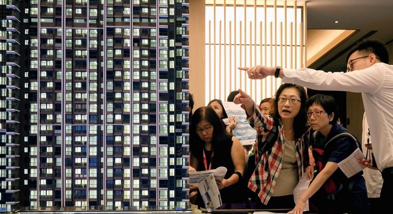 People look at a model of LP6 property development by Nan Fung Group at a sales centre in Hong Kong.