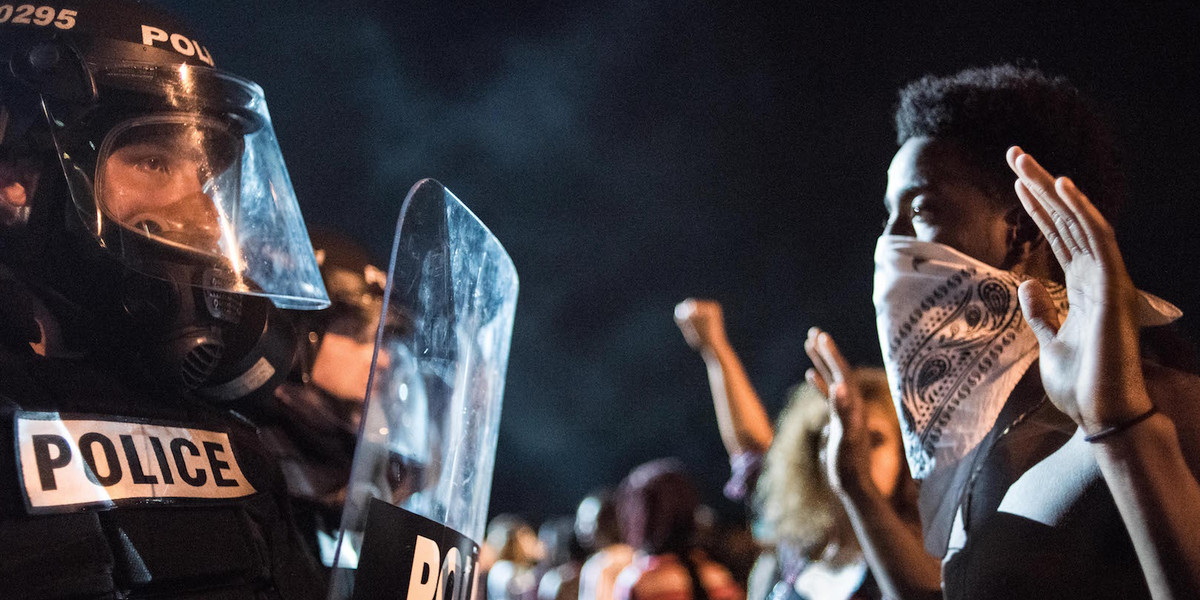 Police officers facing off with protesters on Interstate 85 during protests in the early hours of September 21 in Charlotte, North Carolina.