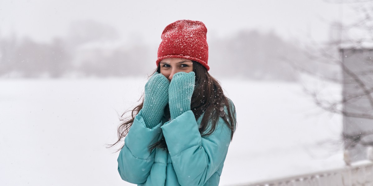 brunette smiles against of snow covered natures