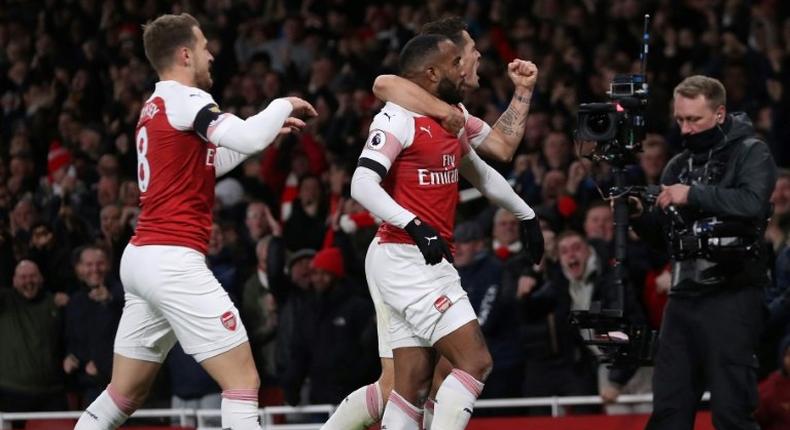 Arsenal striker Alexandre Lacazette (centre) celebrates his equaliser in a 1-1 draw with Liverpool that stretched the Gunners' unbeaten run to 14 matches