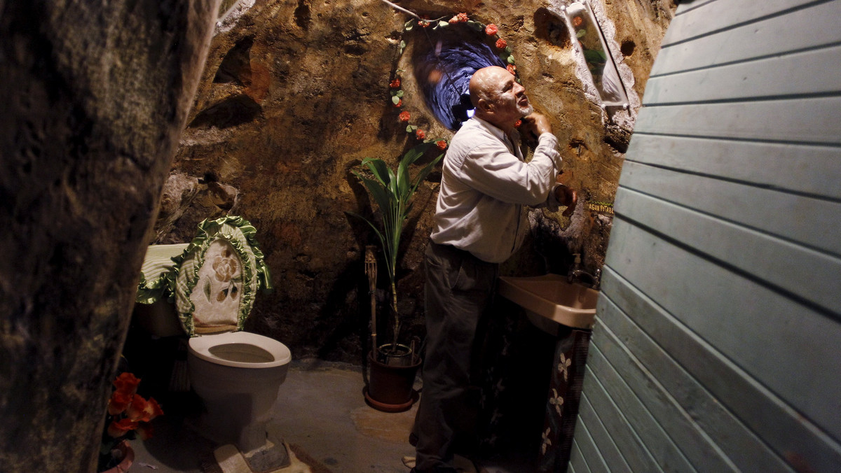 Manuel Barrantes shaves in a bathroom of his house he built underground in San Isidro de Perez Zeledon, Costa Rica