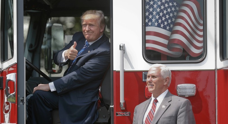 President Donald Trump and Vice President Mike Pence near a fire truck on the White House lawn.