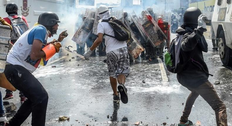 Opposition activists and riot police clash during a protest against President Nicolas Maduro in Caracas, on May 10, 2017