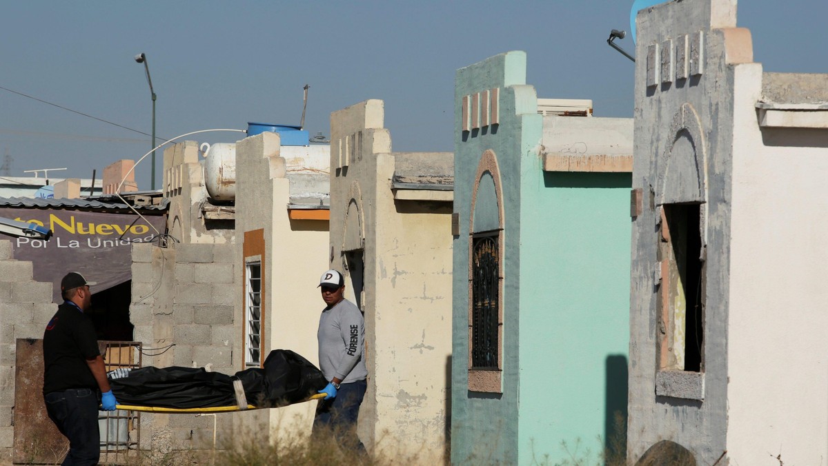 Forensic technicians remove a body from a crime scene where unidentified assailants killed and injured people living in a house at Riberas del Bravo neighbourhood, in Ciudad Juarez