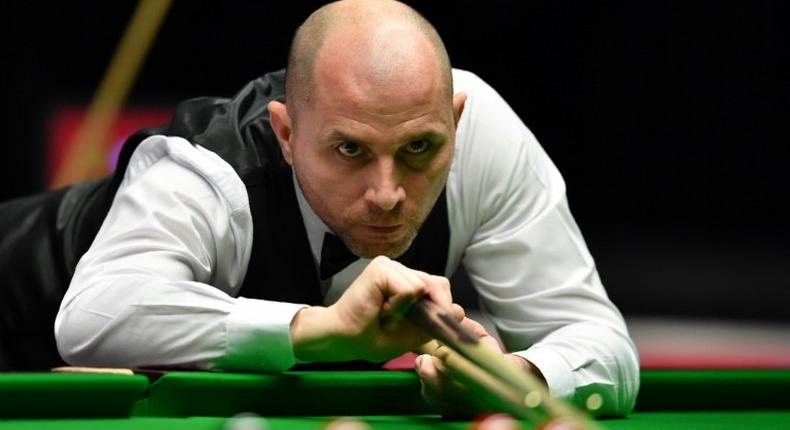 England's Joe Perry plays a shot during his quarter-final match against China's Ding Junhui during the Masters Snooker tournament at Alexandra Palace in London, on January 20, 2017