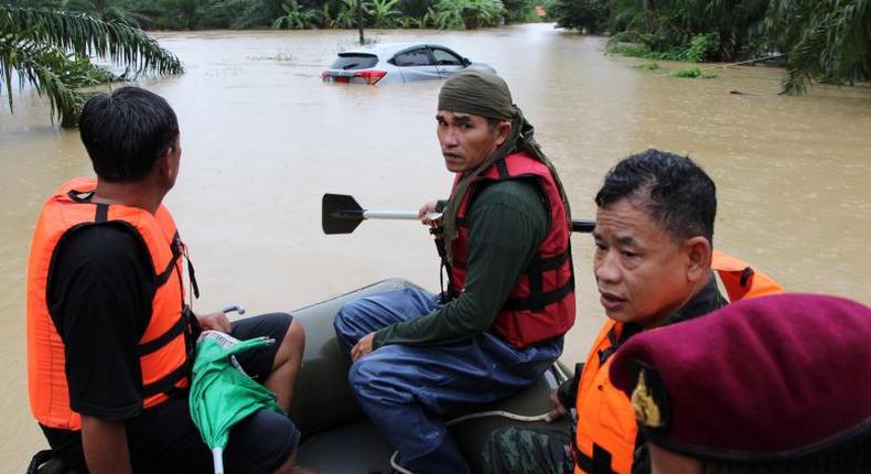 Rescue workers ride a boat as they patrol an area flooded in Sichon District, Nakhon Si Thammarat province, Thailand December 3, 2016. 