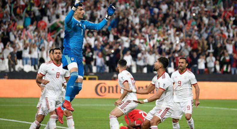 Iran goalkeeper Alireza Beiranvand celebrates after saving an Oman penalty
