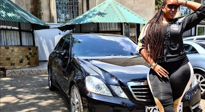 Kiss FM presenter Kamene Goro poses in front of her black Mercedes Benz