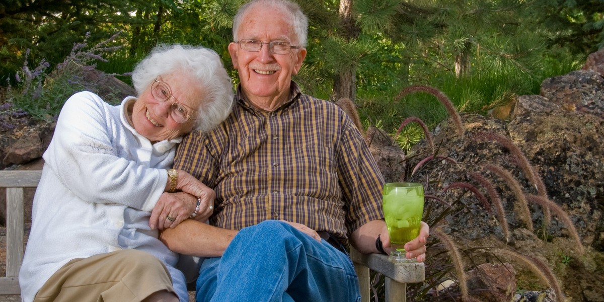 Elderly man and woman sitting on a bench