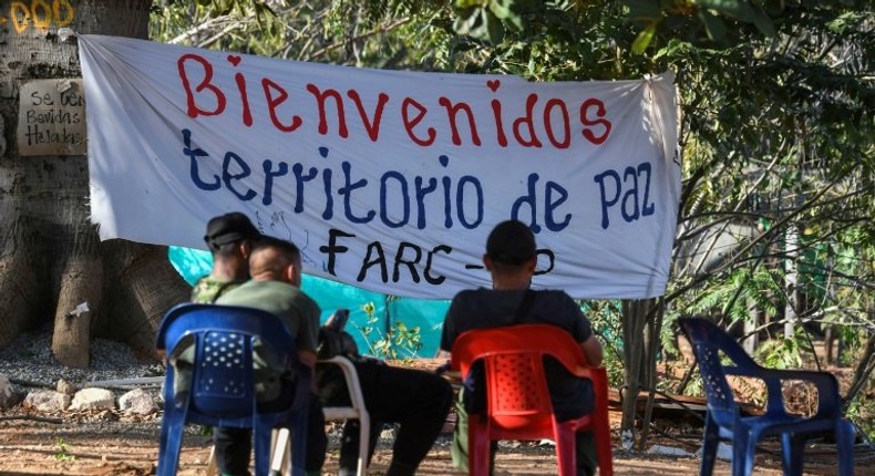 Members of the FARC leftist guerrilla rest at the entrance to the area where the rebels are gathering in the municipality of San Jose de Oriente, Cesar department, northern Colombia on February 28, 2017