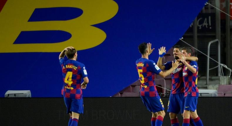 Luis Suarez celebrates scoring against Espanyol on Wednesday as Barcelona kept the pressure on Real Madrid.