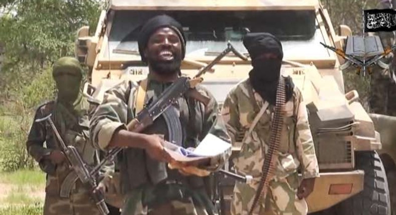 Abubakar Shekau flanked by his followers.