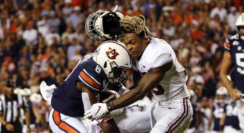 Alabama defensive back Xavier McKinney (15) loses his helmet as Auburn running back Shaun Shivers (8) runs through him for a touchdown during the second half of an NCAA college football game Saturday, Nov. 30, 2019, in Auburn, Ala. (AP Photo/Butch Dill)