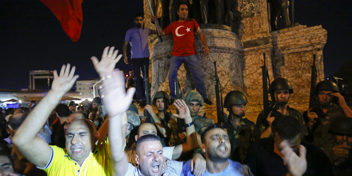 People demonstrate in front of the Republic Monument at the Taksim Square in Istanbul, Turkey, July 16, 2016.