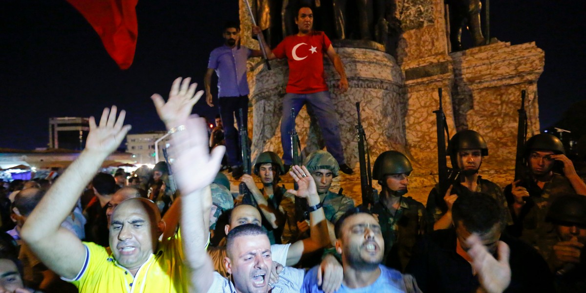 People demonstrate in front of the Republic Monument at the Taksim Square in Istanbul, Turkey, July 16, 2016.