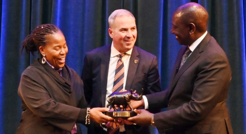 UDA presidential aspirant Dr William Ruto presents a gift to Loyola University, Maryland associate professor Dr Karsonya Kaye Wise Whitehead after their discussion at the Karson Institute on March 2, 2022