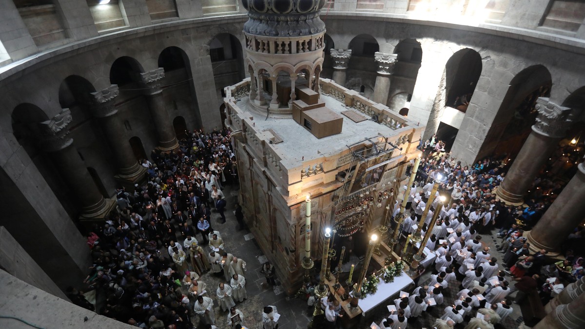 Christian worshippers surround the Edicule as they take part in a Sunday Easter mass procession in t