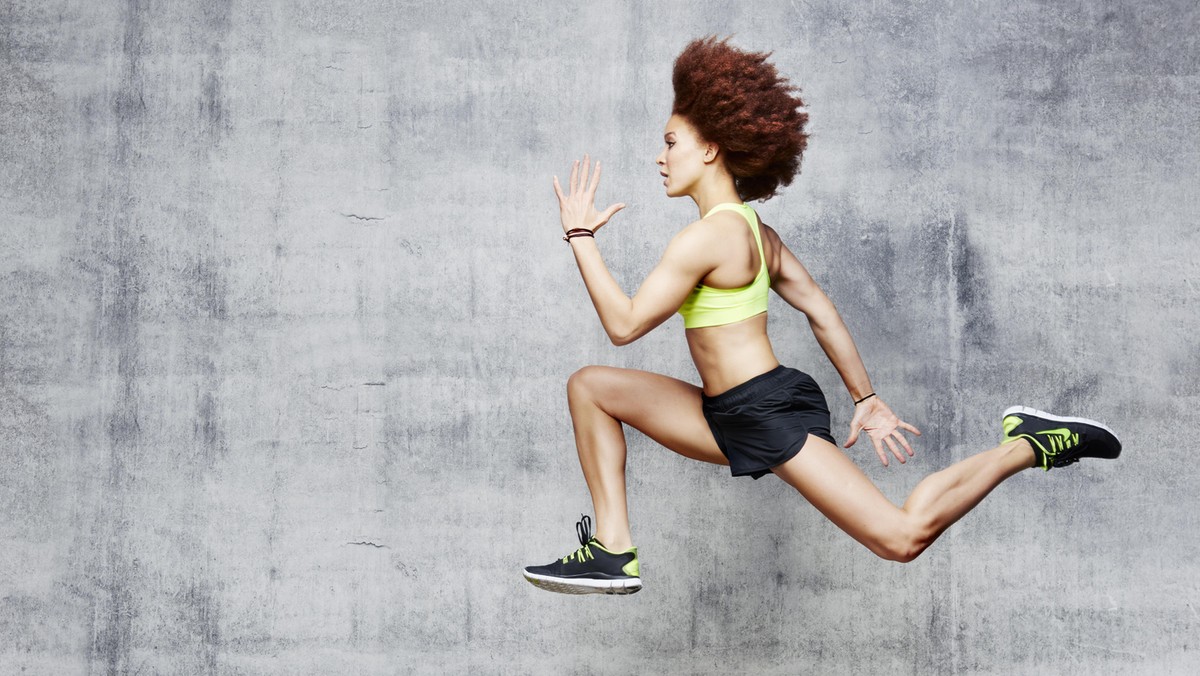 Woman jumping in air in urban studio