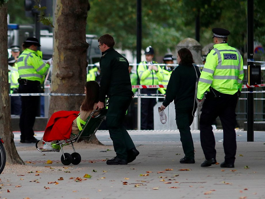 An injured woman is wheeled away.