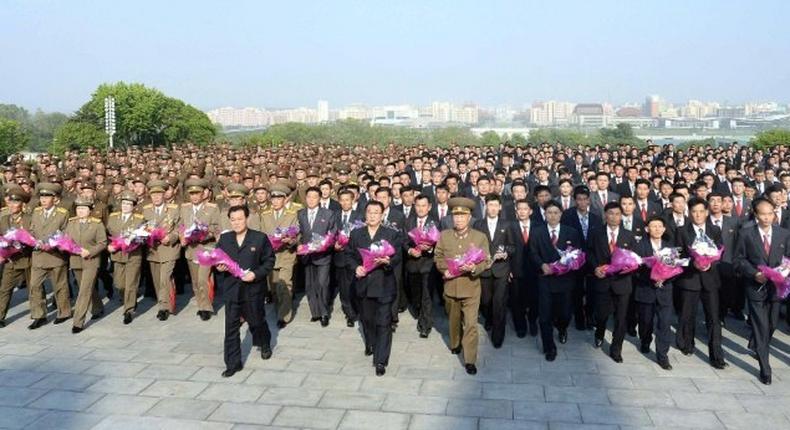 This picture released by North Korea's official Korean Central News Agency (KCNA) on May 19, 2017 shows developers of the strategic ballistic rocket Hwasong-12 visiting the statues of former leaders in Pyongyang