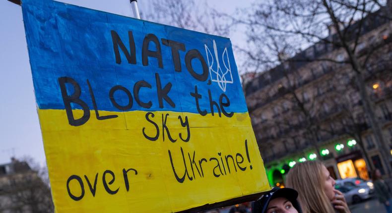 A protestor calls on NATO to enforce a no-fly zone over Ukraine during a demonstration in Paris, France on Feb. 26, 2022.