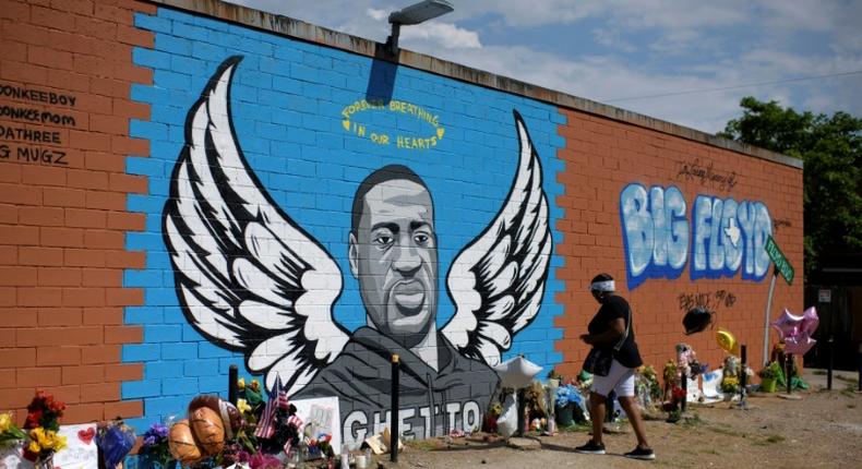 Visitors pay their respects to George Floyd in front of a mural in Houston, Texas on Monday, June 8, 2020