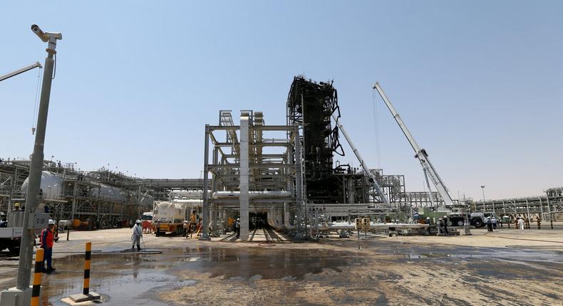 FILE PHOTO: Workers are seen at the damaged site of Saudi Aramco oil facility in Khurais, Saudi Arabia, September 20, 2019. REUTERS/Hamad l Mohammed//File Photo