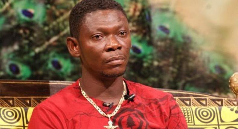 Agya Koo in a red T-shirt