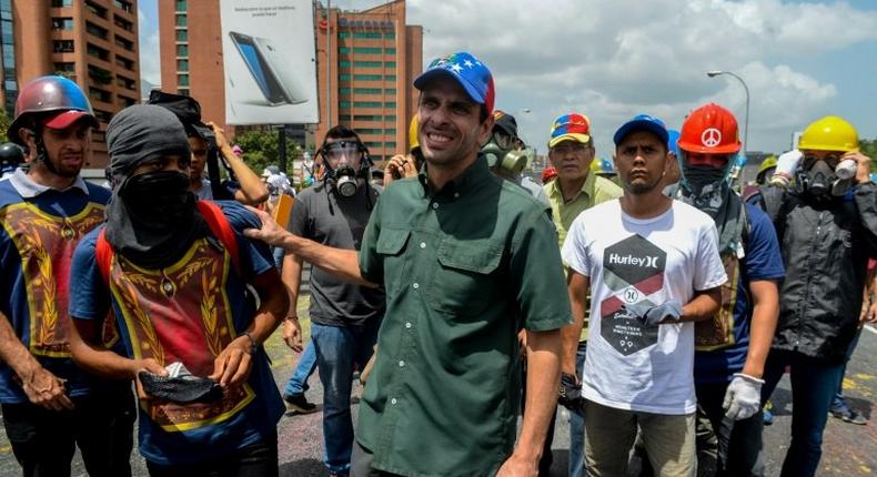 Opposition leader Henrique Capriles (C) takes part in a demonstration against President Nicolas Maduro in Caracas