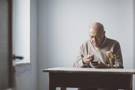 An elderly man look for some money from his wallet