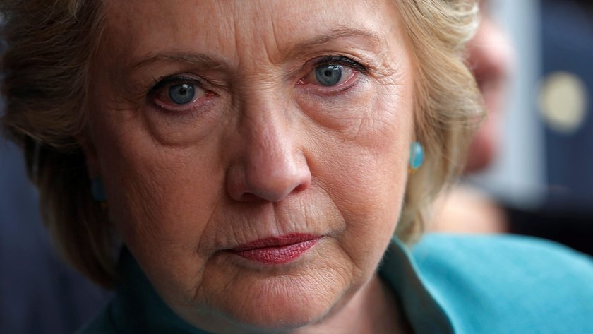 U.S. Democratic presidential nominee Hillary Clinton listens to a supporter outside a campaign field