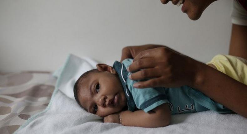 Mariam Araujo, 25, plays with Lucas, her 4-months old second child and born with microcephaly as they wait for a physiotherapy session in Pedro I hospital in Campina Grande, Brazil, February 17, 2016. 