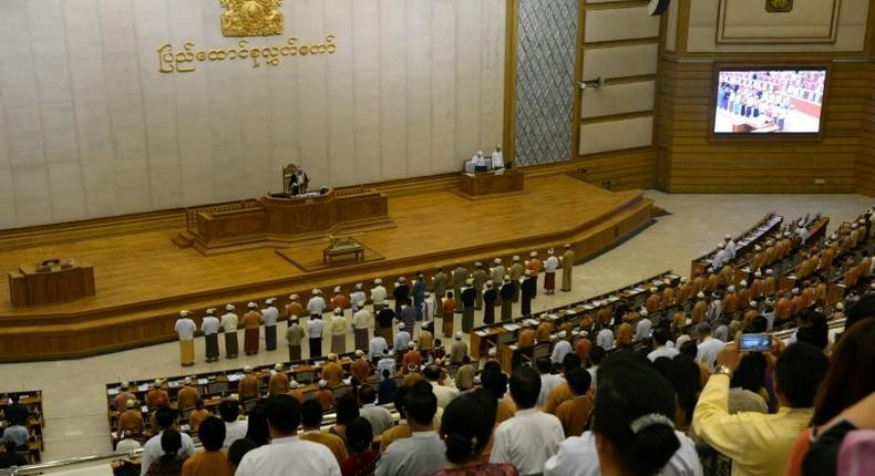 Myanmar ministers are sworn into office by Upper House Speaker Mahn Win Khine (on podium) during a ceremony at the parliament in Naypyidaw on March 30, 2016