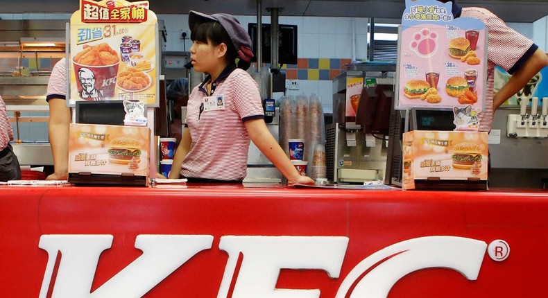 KFC's staff wait for customers at its restaurant in Beijing on October 9, 2013.