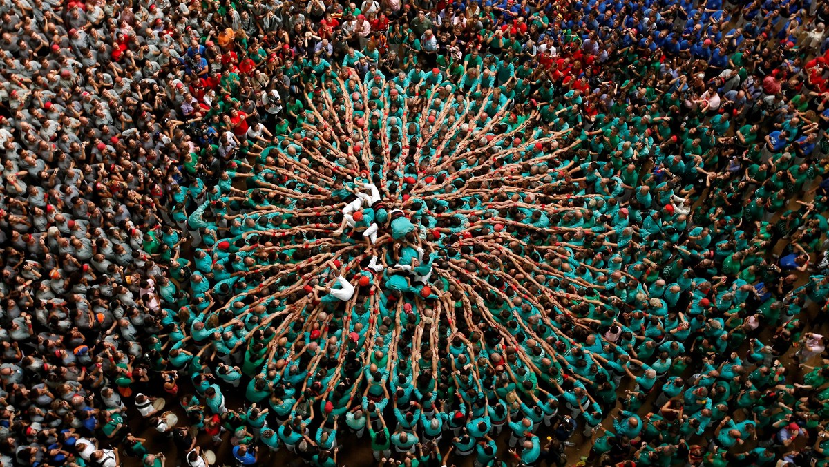 Castellers de Vilafranca fall down after forming a human tower called castell during a biannual competition in Tarragona city