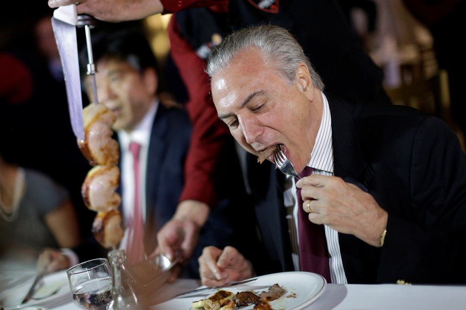 Brazil's President Michel Temer eats barbecue in a steak house after a meeting with ambassadors of meat-importing countries, in Brasilia, Brazil, March 19, 2017.