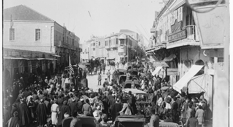 People crowd around a steamroller rolling down Jerusalem street.Matson photograph collection via Library of Congress.