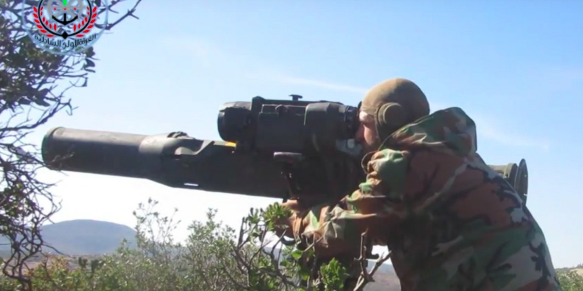A Syrian rebel targets Assad tanks with a TOW missile