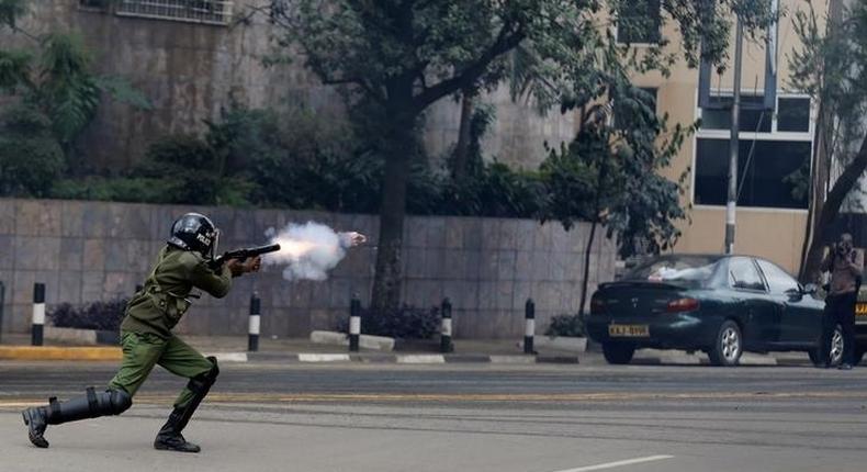 A riot policeman fires a teargas canister to disperse supporters of Kenya's opposition Coalition for Reforms and Democracy (CORD) during a protest at the premises hosting the headquarters of Independent Electoral and Boundaries Commission (IEBC) to demand the disbandment of the electoral body ahead of next year's election in Nairobi, Kenya, May 23, 2016. 