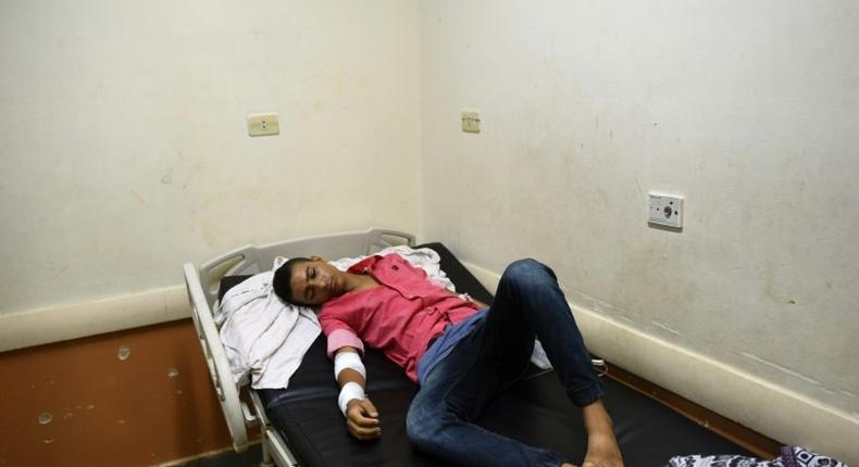 Rescued migrant Sameh Mohamed Ahmed Abdel Dayem, an 18-year-old Egyptian student from Kafr El-Sheikh, lies in a bed at Rashid hospital in Rosetta, northern Egypt, on September 21, 2016